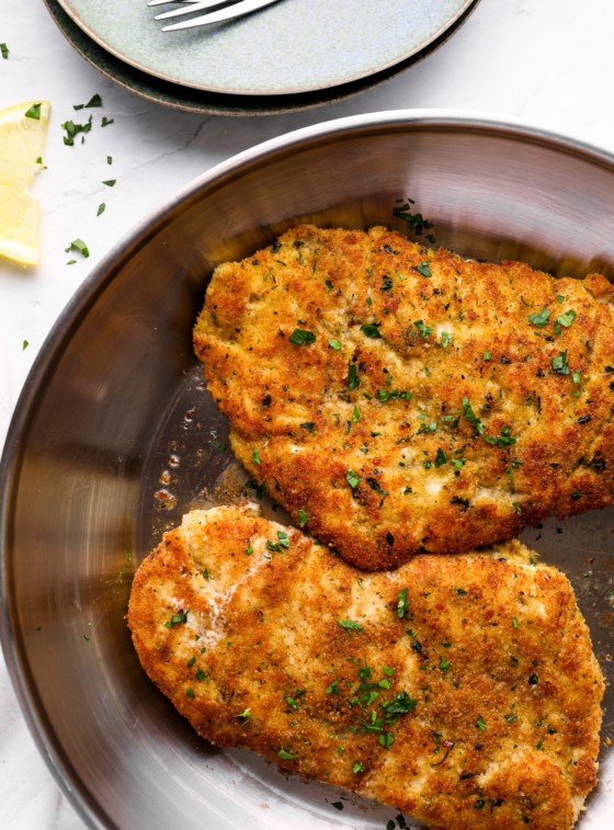 Parmesan crusted chicken in a skillet.