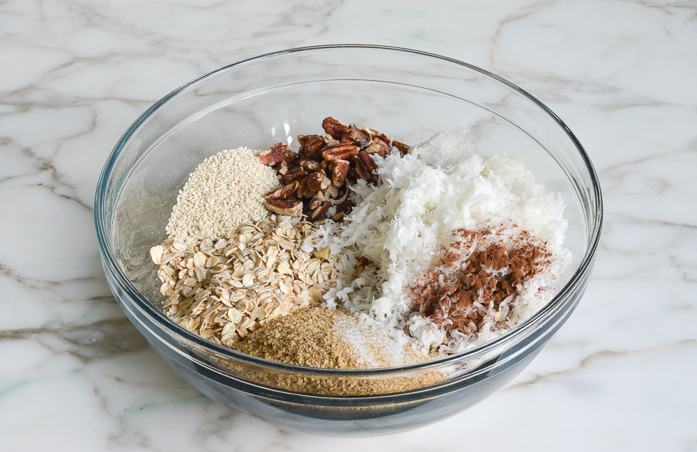 oats, almonds, pecans, walnuts, sunflower seeds, sesame seeds, wheat germ, coconut, cinnamon and salt in a large mixing bowl