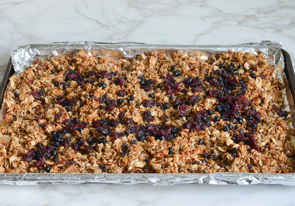 adding dried fruit to baked granola