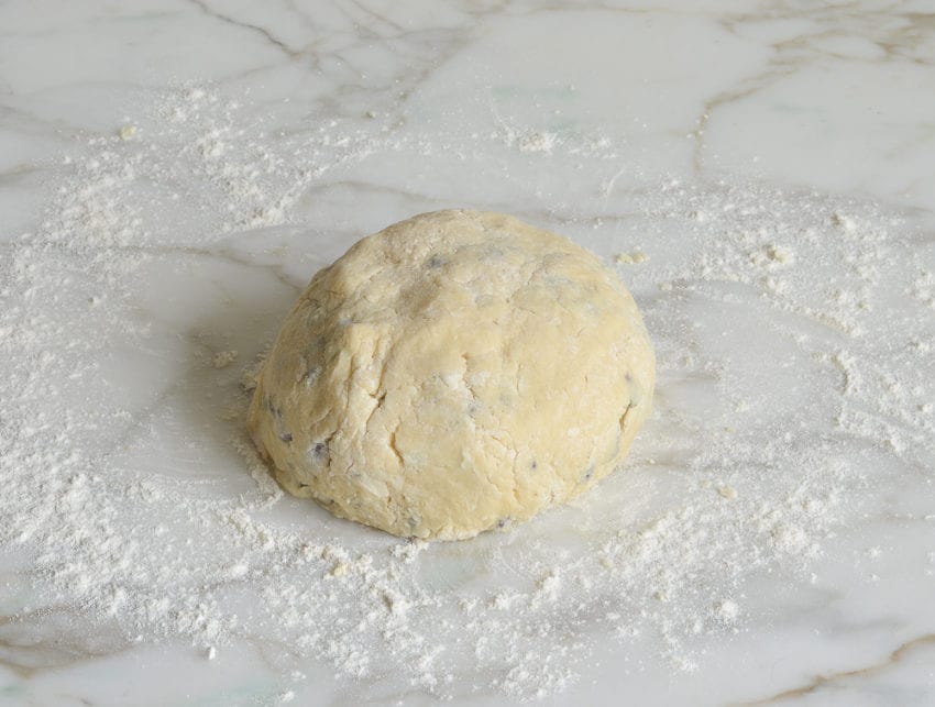 chocolate chip scone dough gently kneaded into a ball on work surface