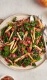 kale, apple, and pancetta salad on plate