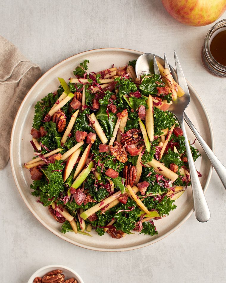 kale, apple, and pancetta salad on plate