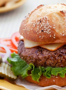 Steakhouse burger on a plate with toppings.