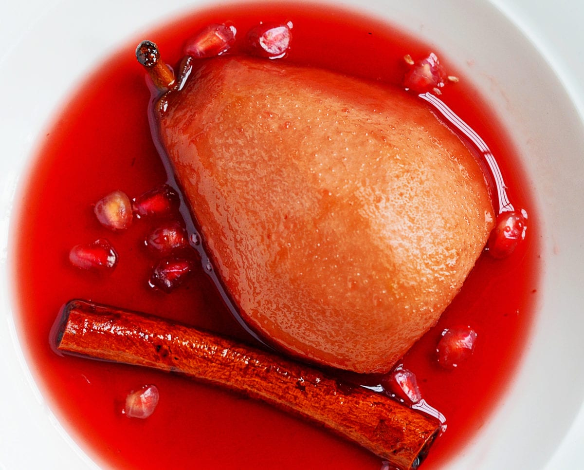 baked pears in pomegranate syrup in bowl