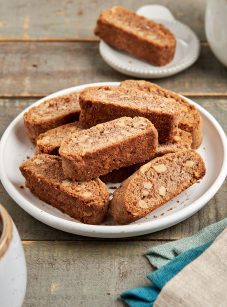 walnut and cinnamon biscotti on a plate with coffee