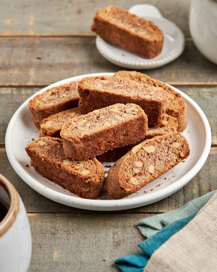 walnut and cinnamon biscotti on a plate with coffee