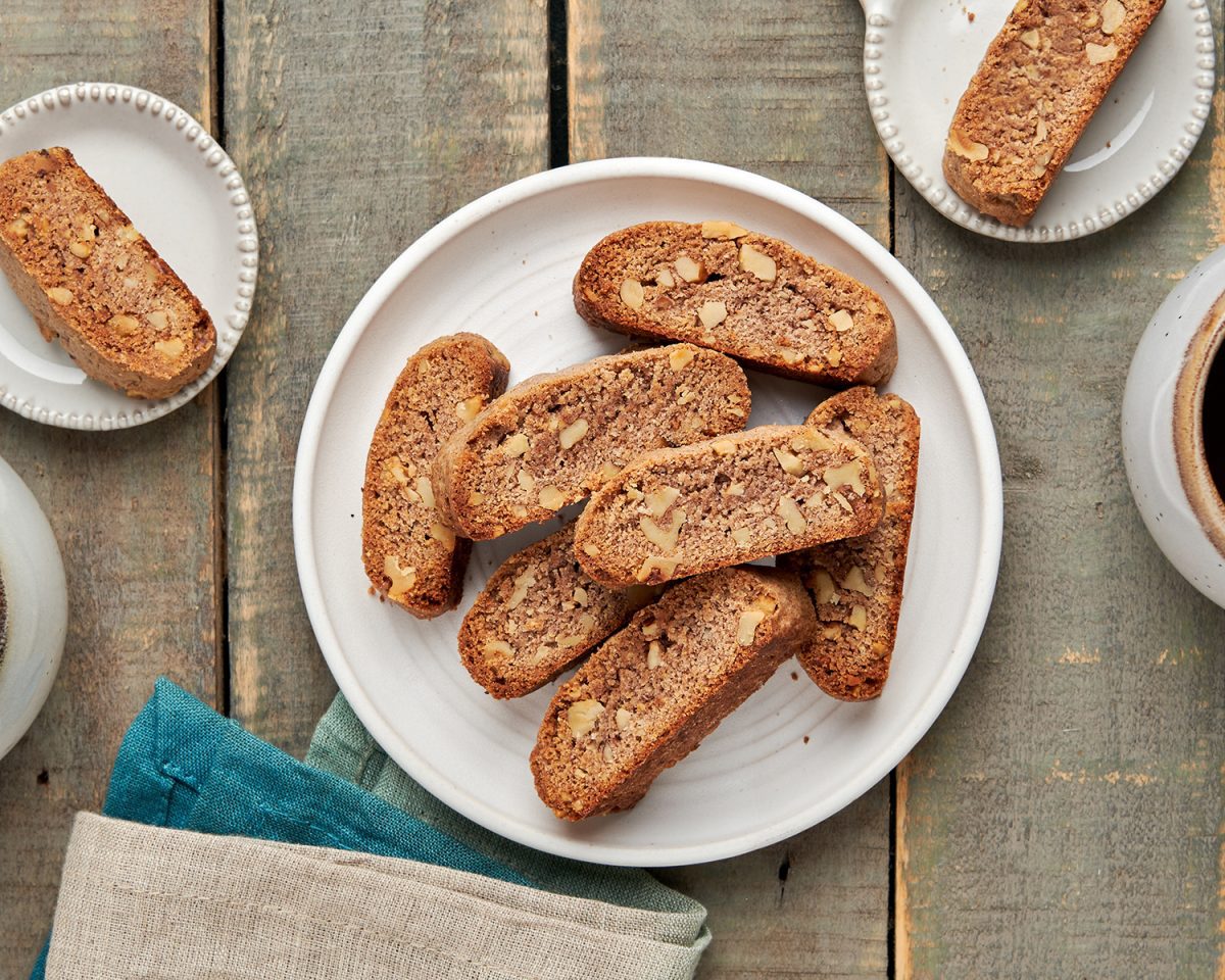 walnut and cinnamon biscotti on a plate with coffee