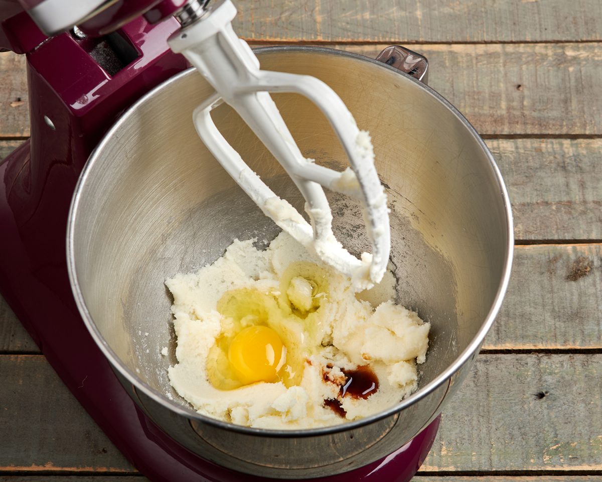 adding egg and vanilla to creamed butter mixture