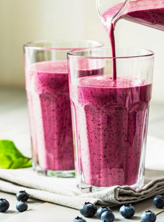 pouring berry smoothie into glasses