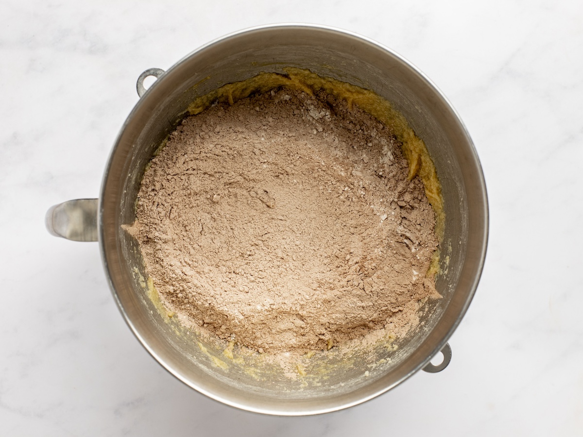 adding dry ingredients to creamed butter, sugar, and eggs