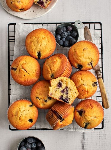 blueberry cornbread muffins cooling on rack