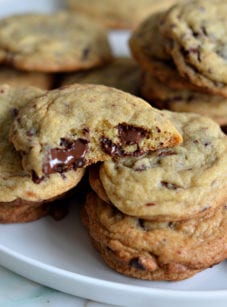 chocolate chunk cookies stacked on plate