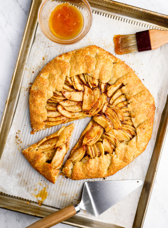 Rustic French apple tart with one slice pulled out.