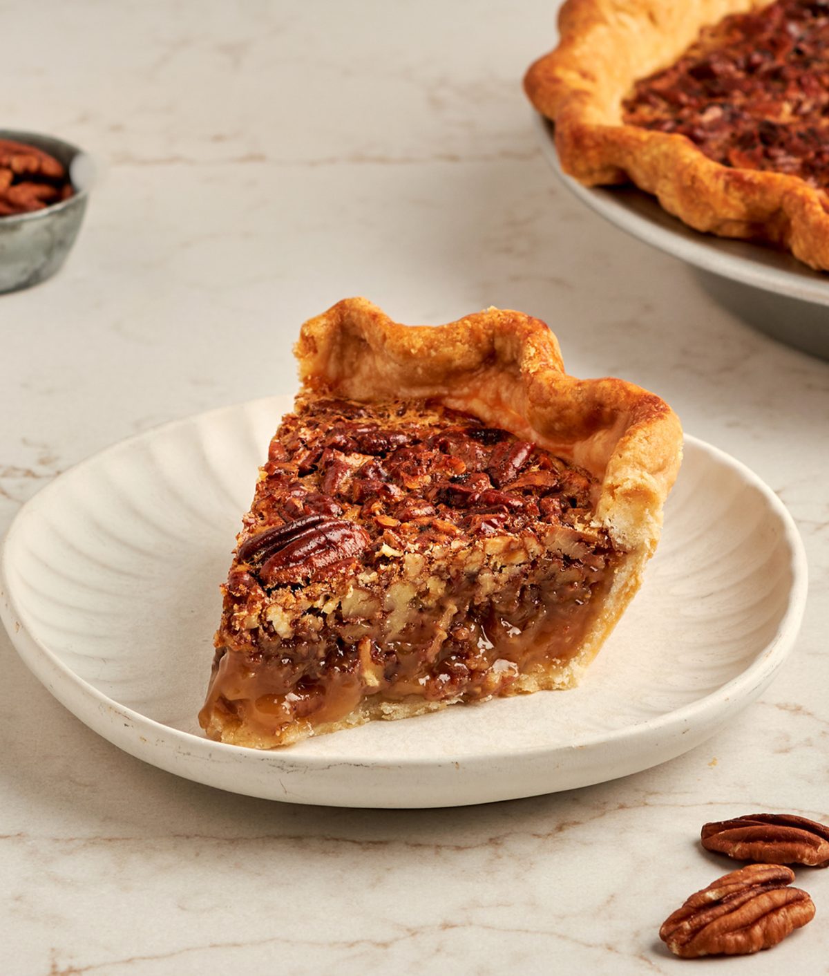 slice of bourbon pecan pie on white plate