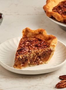 slice of bourbon pecan pie on white plate