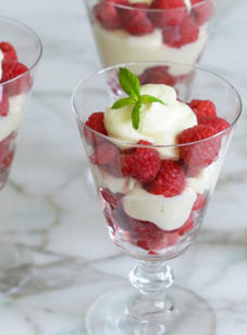 Raspberry Parfaits in stemmed glasses.