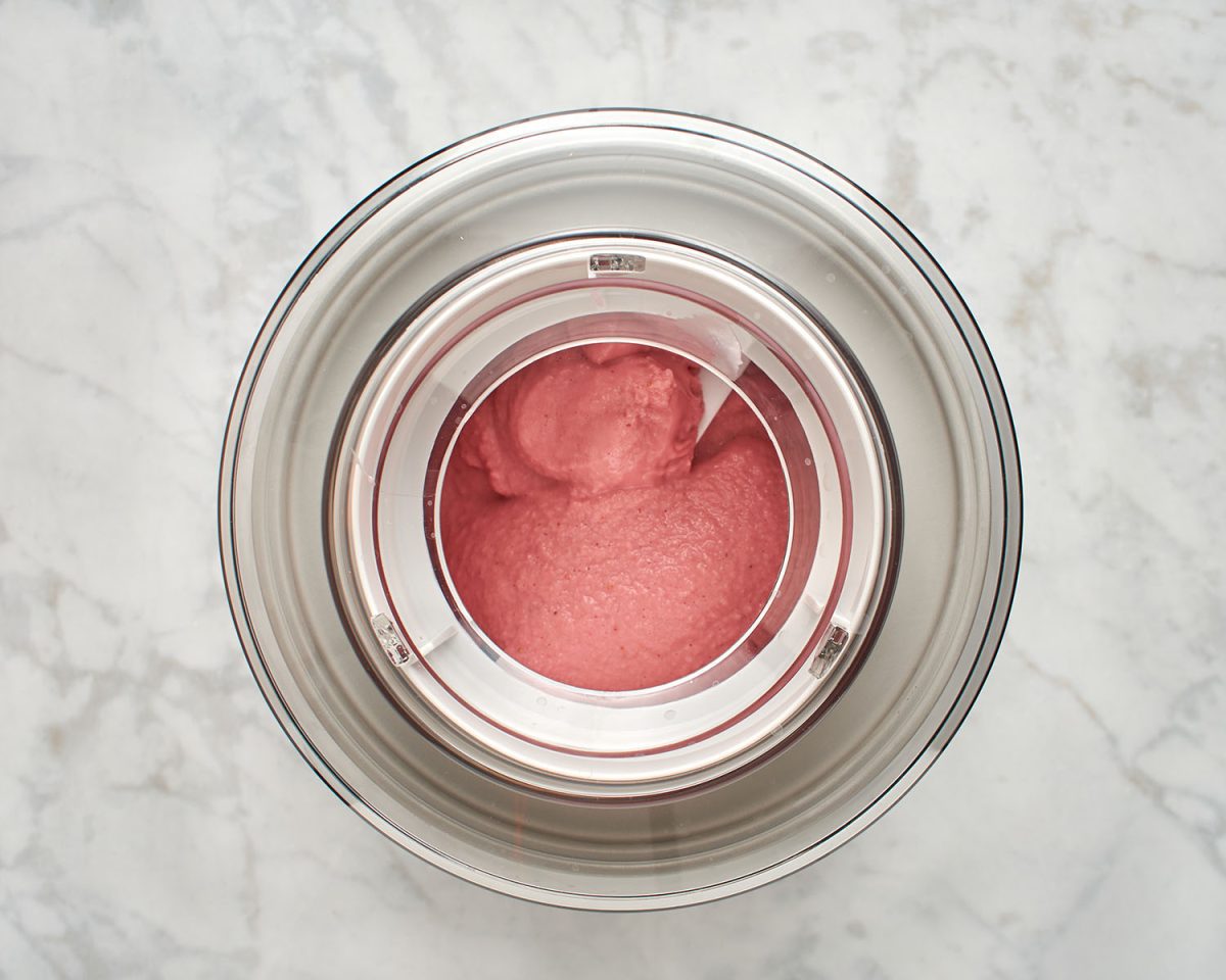 churning the strawberry frozen yogurt in an ince cream machine.