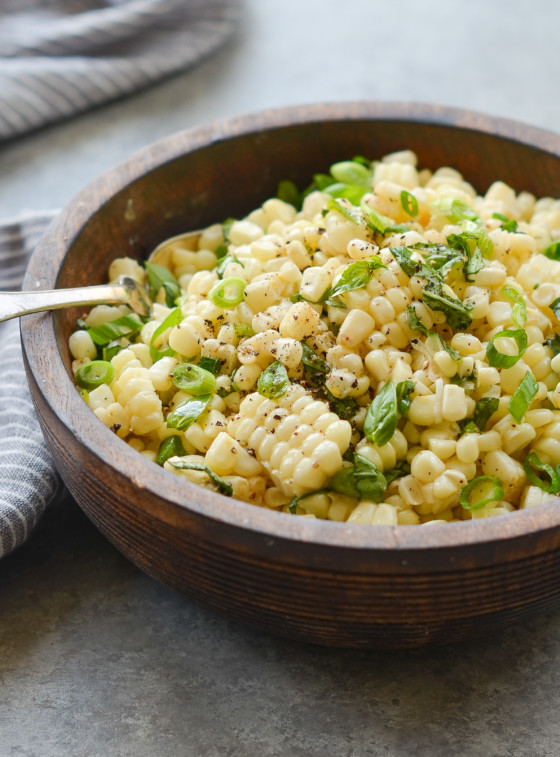 Fork in a bowl of fresh corn salad.