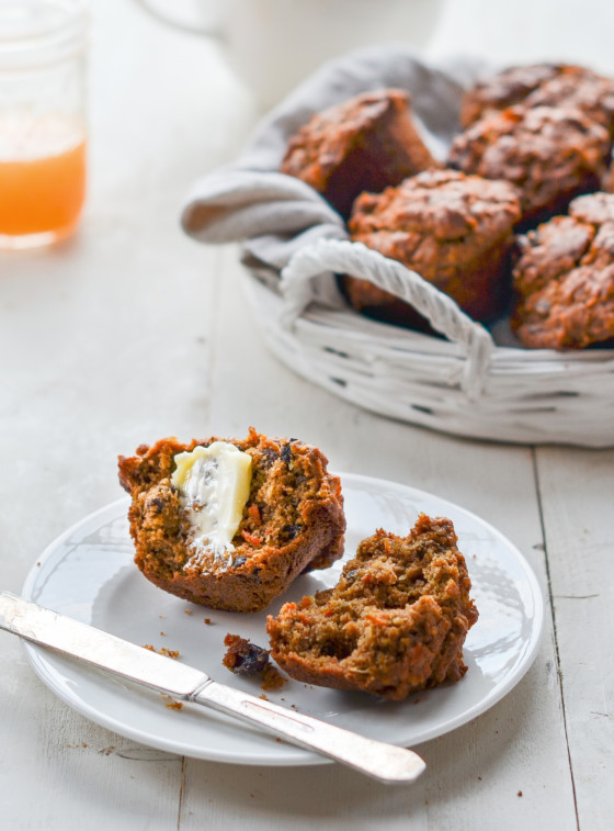 Halved morning glory muffin with butter.