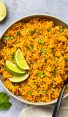 bowl of mexican rice with lime wedges