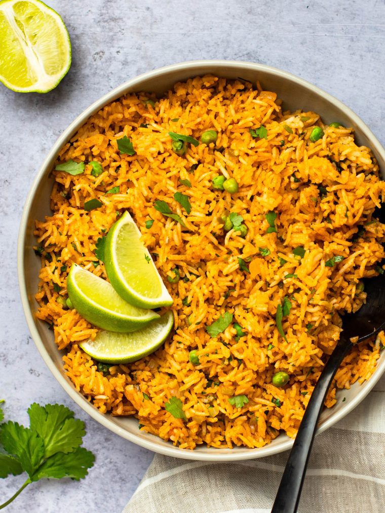 bowl of mexican rice with lime wedges