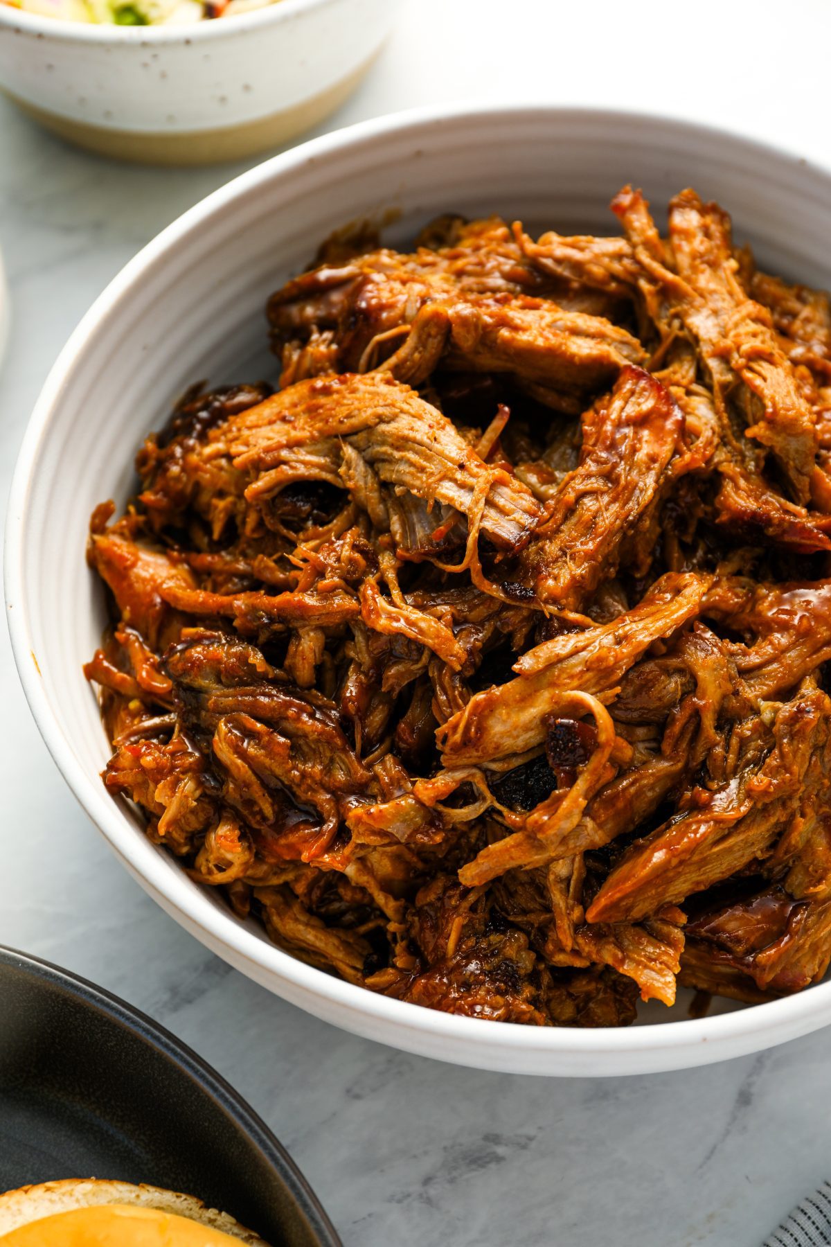 pulled pork tossed with BBQ sauce in bowl