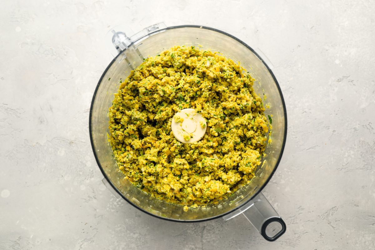 ground chickpeas, spices, and aromatics in food processor