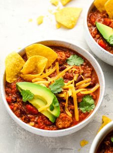 bowls of turkey chili topped with all the fixings