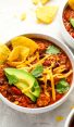 bowls of turkey chili topped with all the fixings