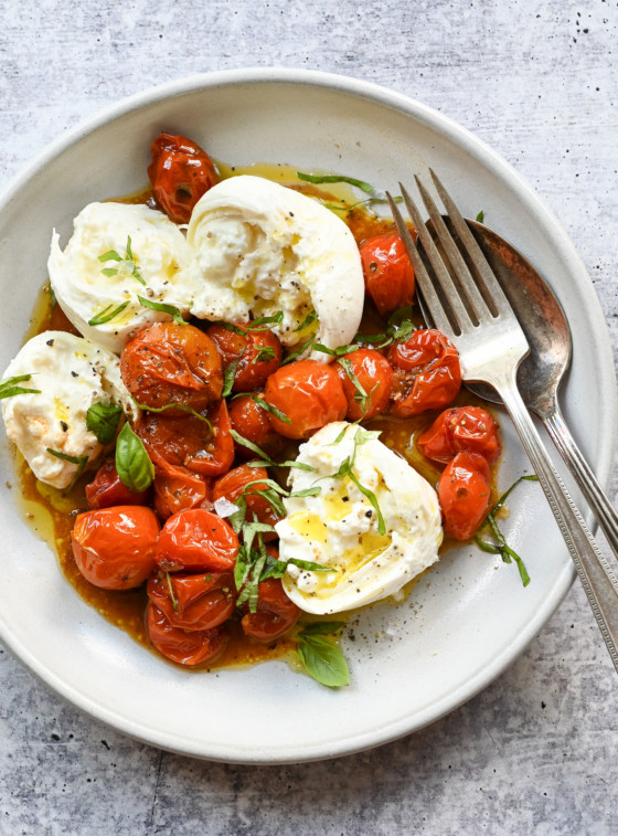 Plate of slow-roasted cherry tomatoes and burrata.