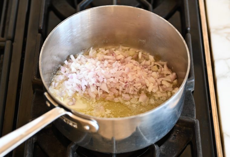 adding the shallots to the pan