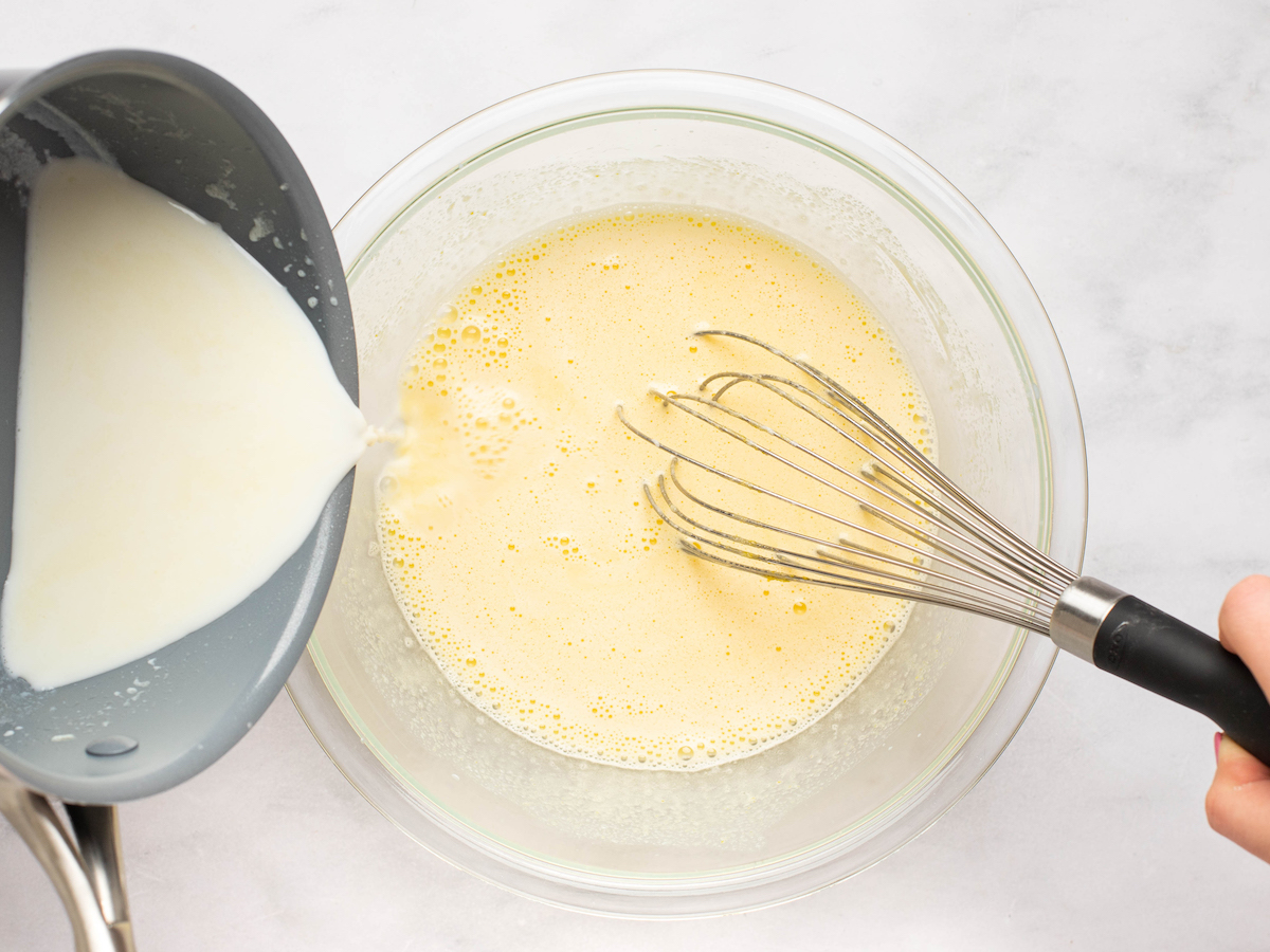 adding remaining hot milk mixture to bowl