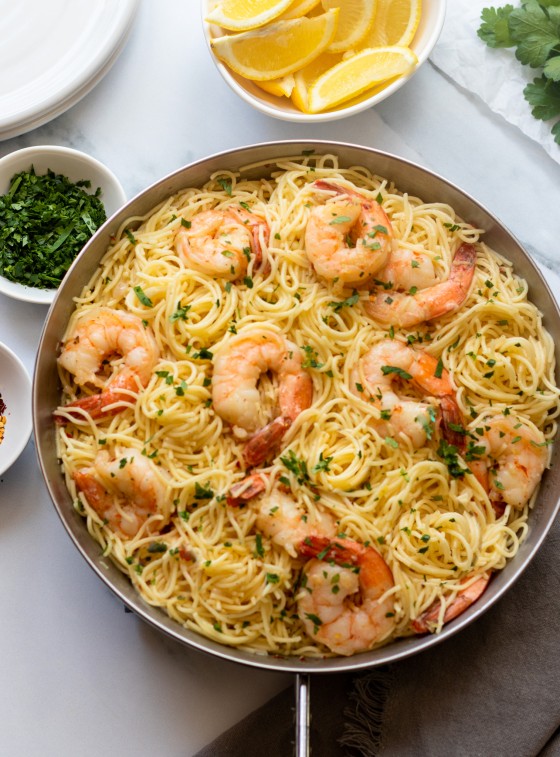 Shrimp scampi with noodles in a large bowl.