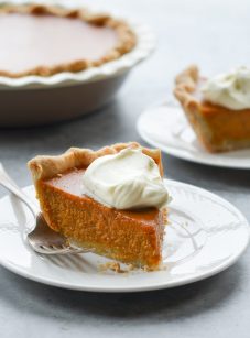 slice of pumpkin pie on plate with whipped cream