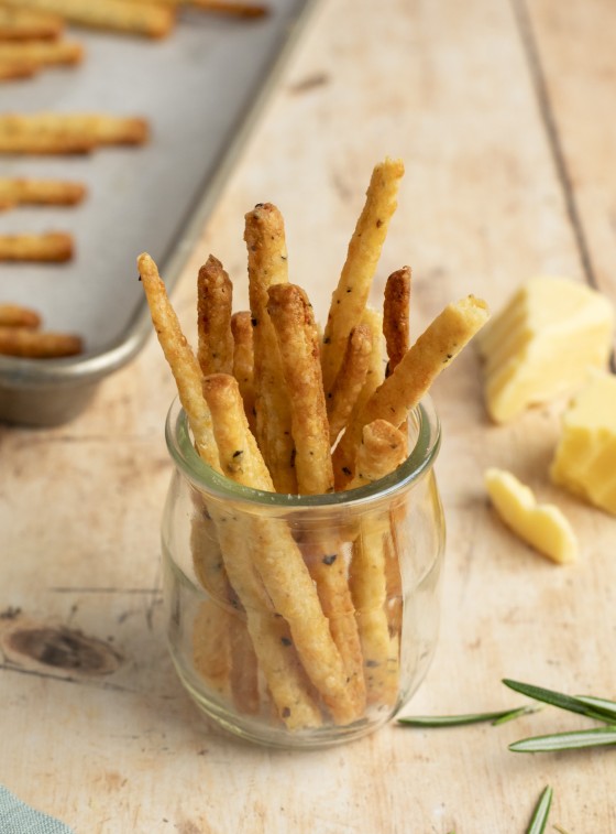 cheese straws in jar on table.