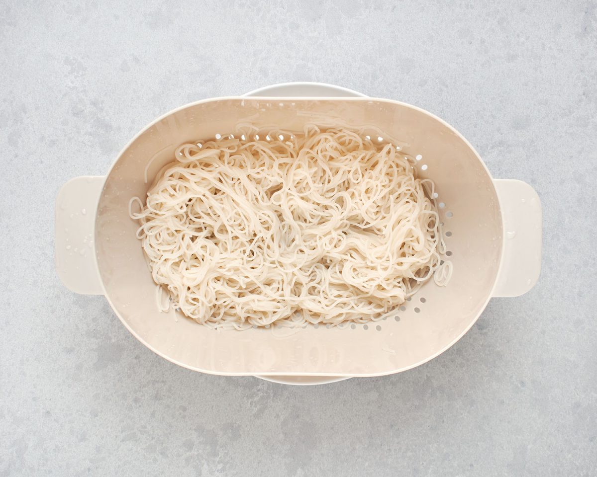 rice vermicelli noodles in strainer.