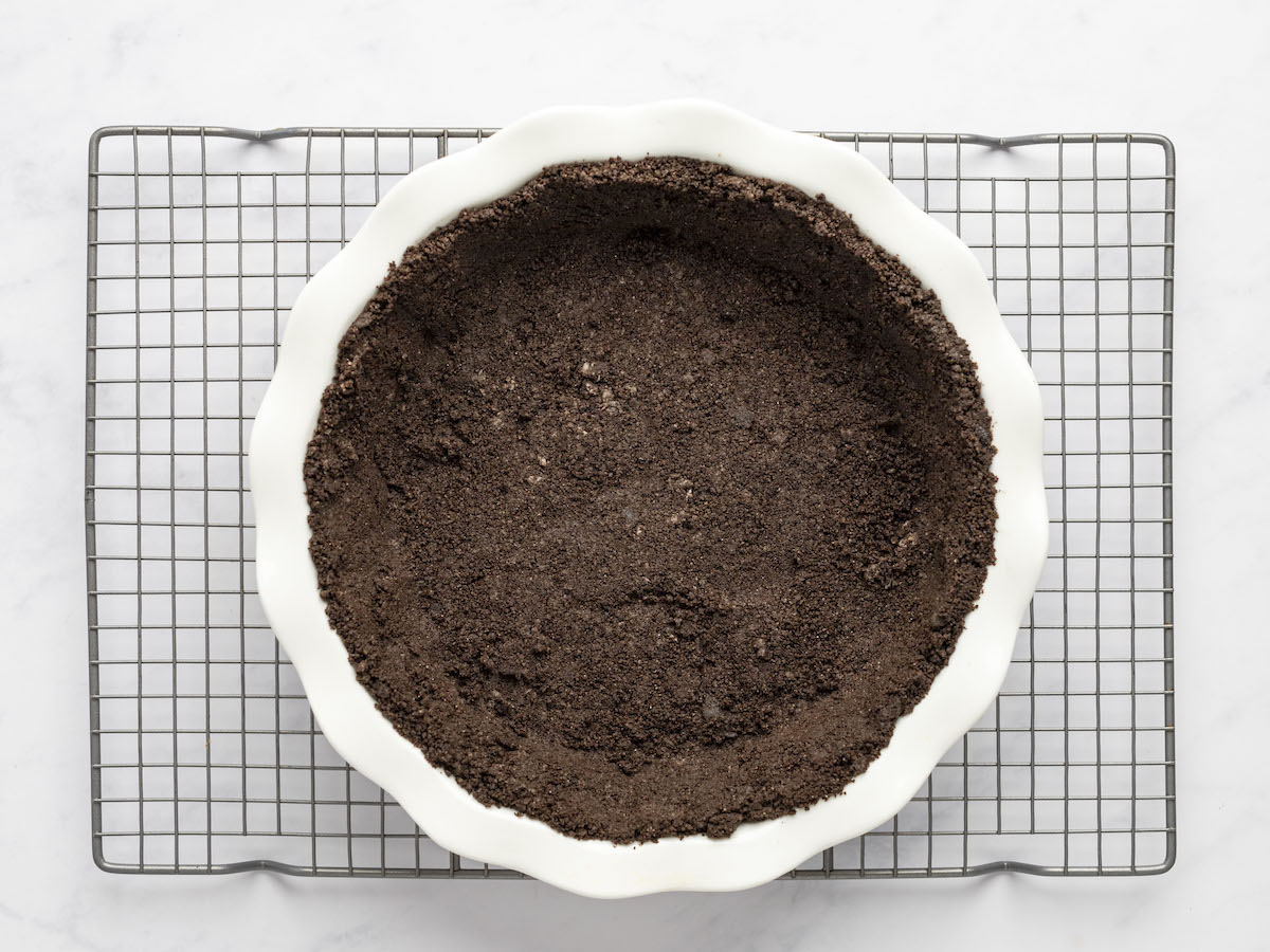 oreo cookie crust cooling on baking rack