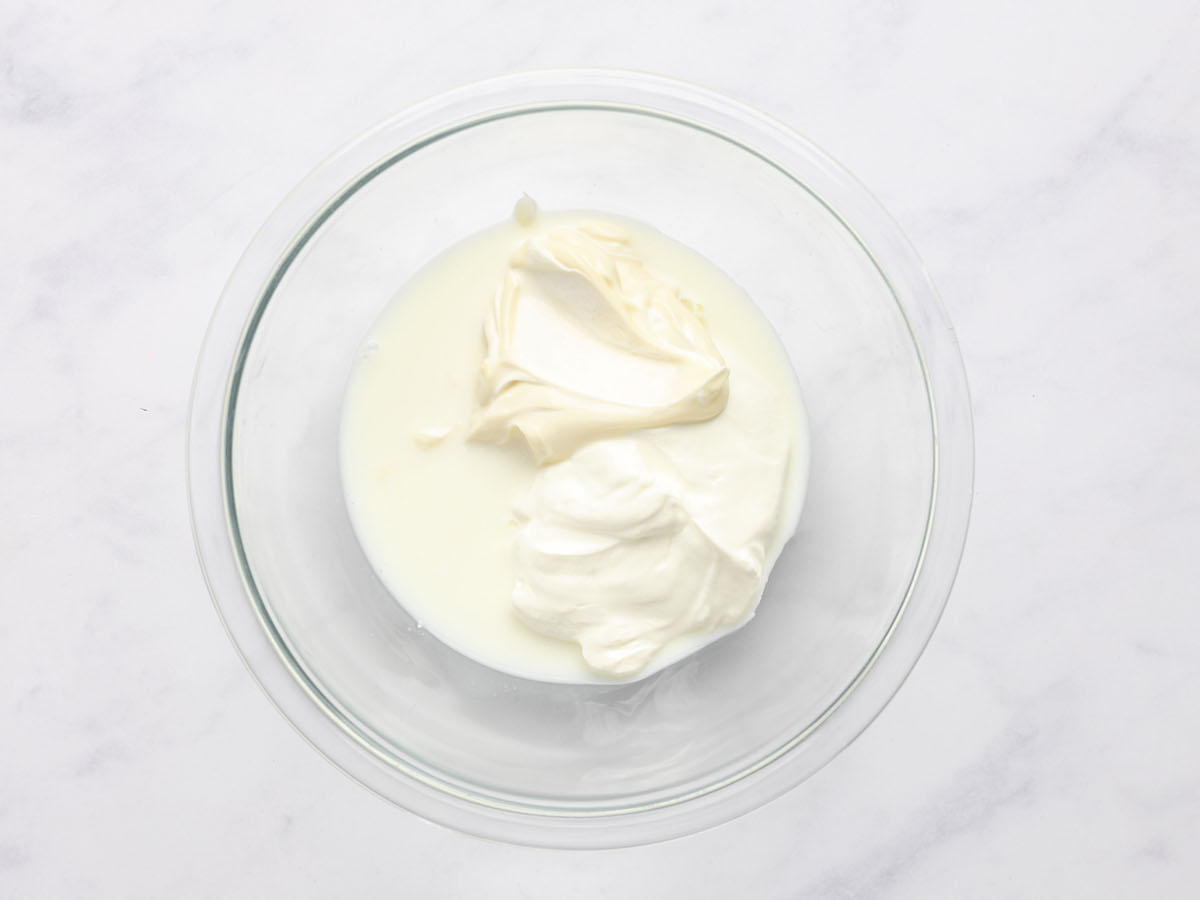 sour cream, mayonnaise, and milk in mixing bowl.