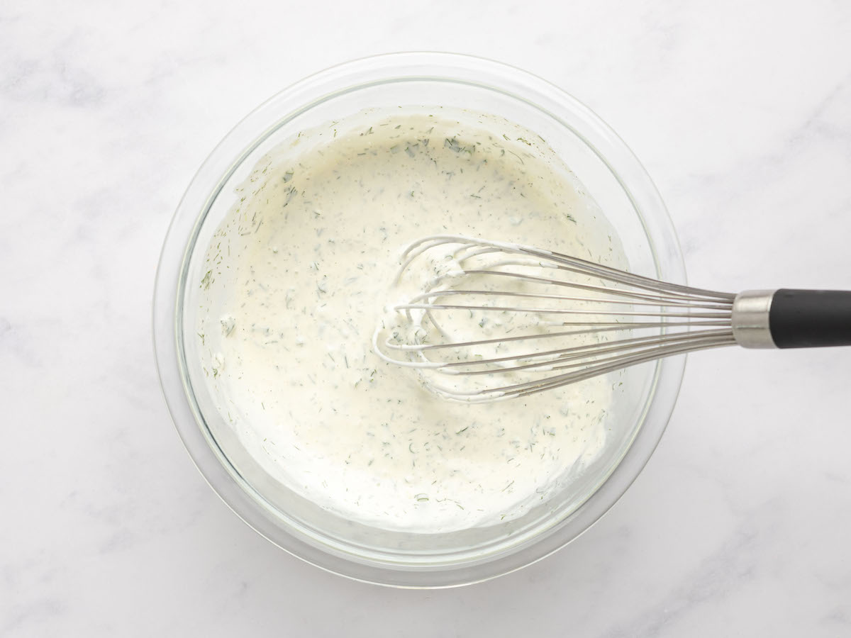 ranch dressing whisked in mixing bowl.
