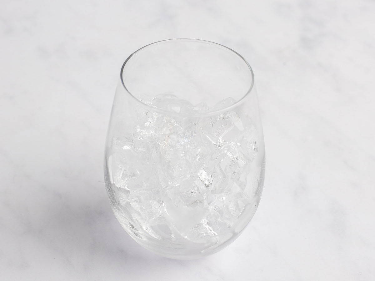 glass filled halfway with ice cubes