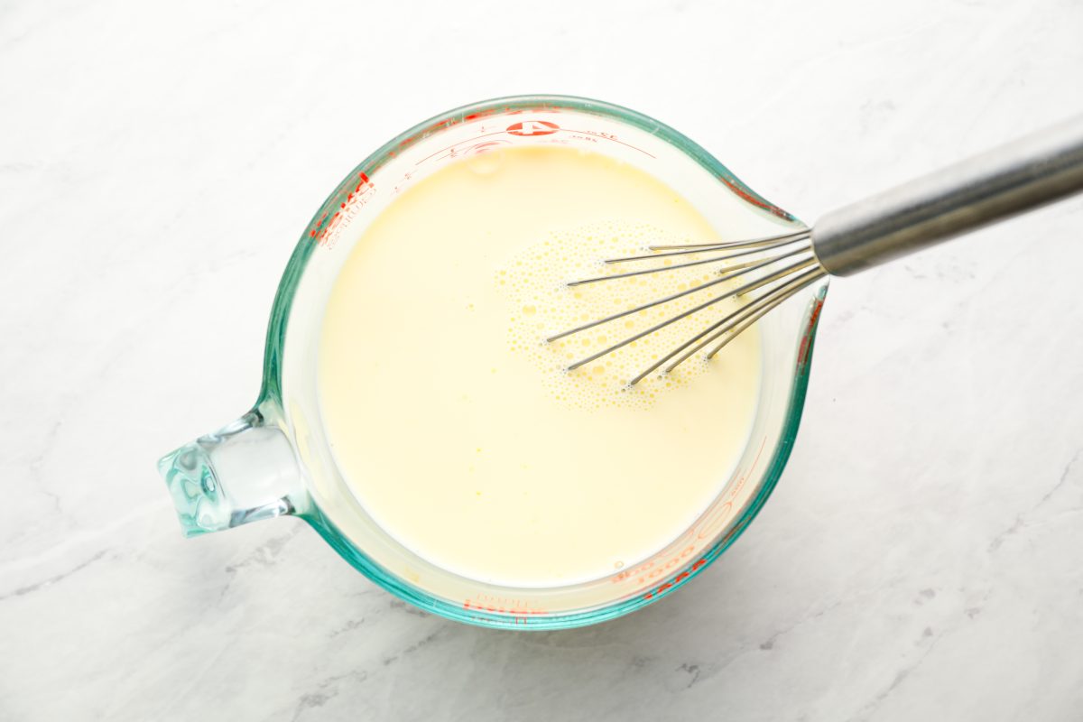 whisking egg yolks and milk in large measuring cup