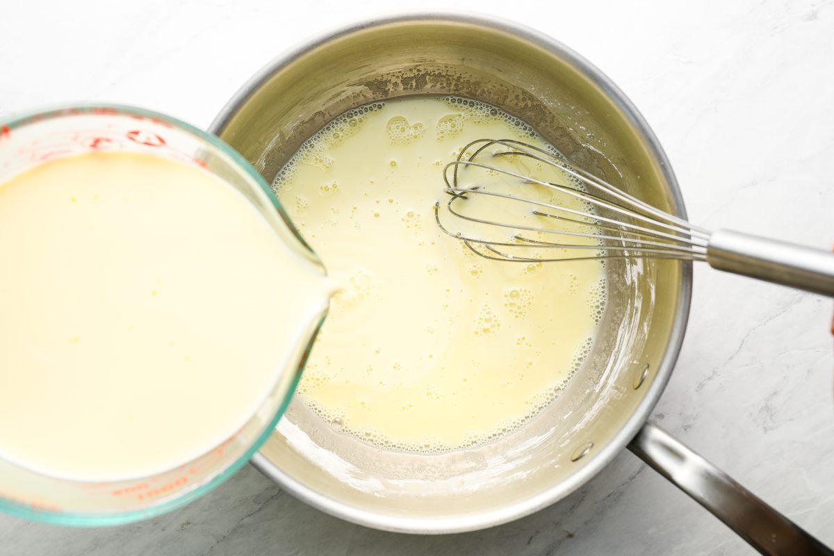 pouring milk mixture into the sauce pan