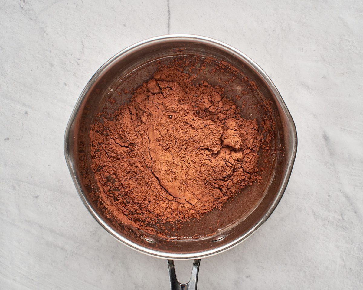 cocoa powder added to cream/chocolate mixture in medium saucepan