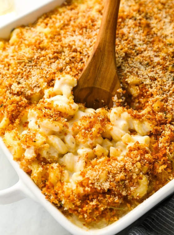 mac and cheese in baking dish with serving spoon