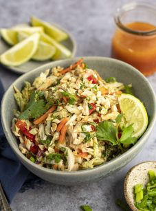 Vietnamese Shredded Chicken Salad in Bowl with Lime Wedges