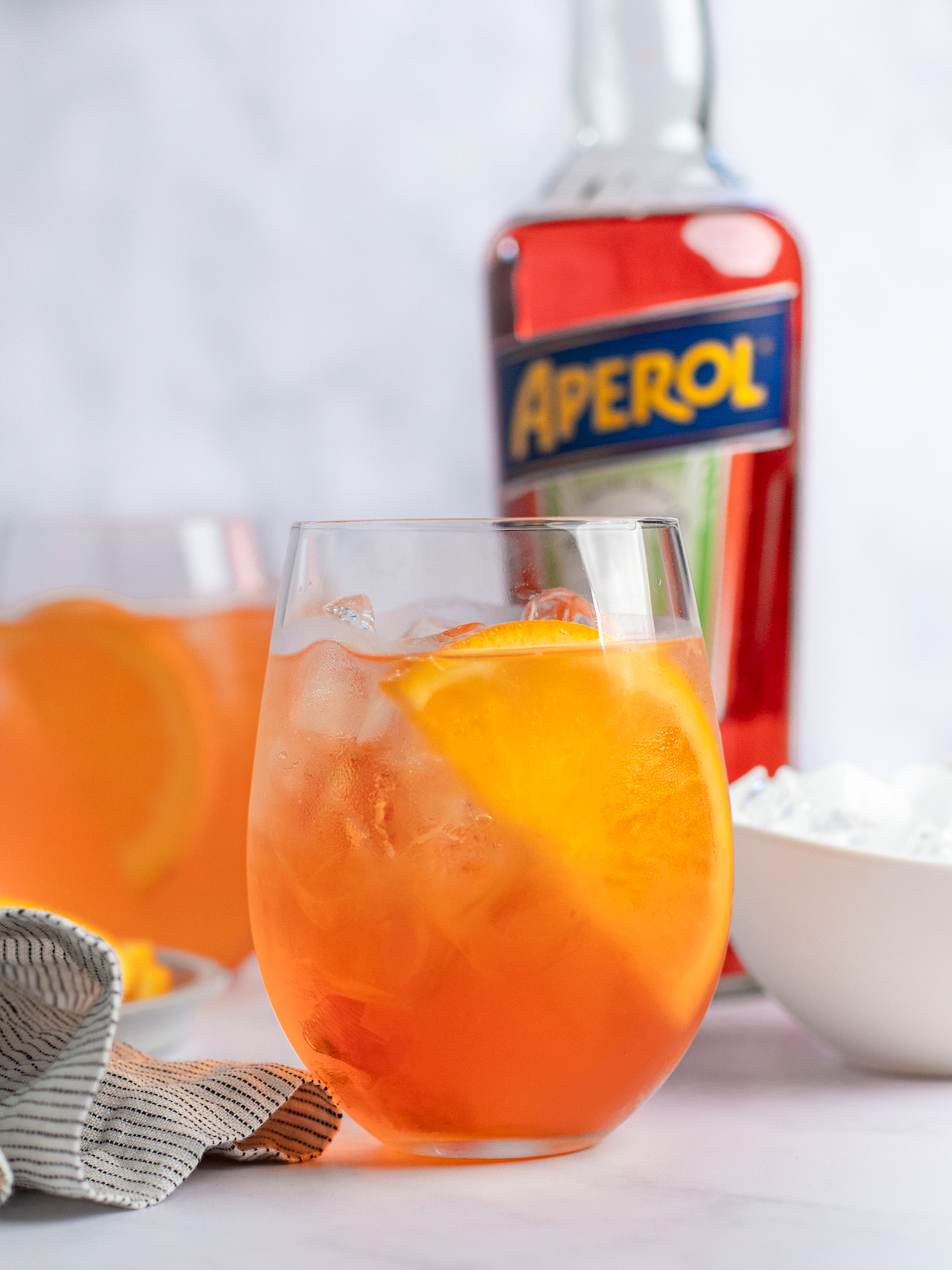 aperol spritz with bottle of aperol