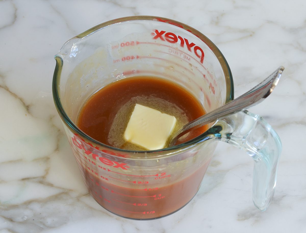 stirring the butter in  caramel sauce