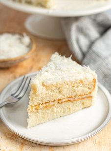 slice of coconut cake on white plate.