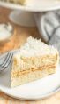 slice of coconut cake on white plate.