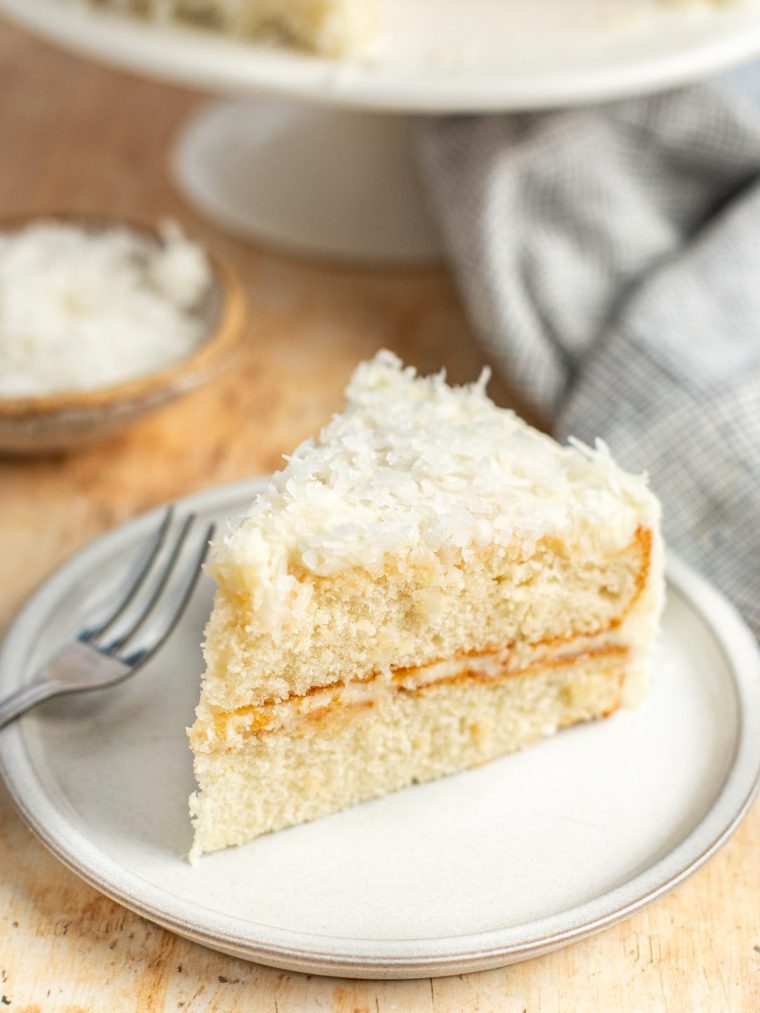 slice of coconut cake on white plate.